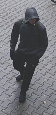 mężczyzna podejrzewany o kradzież roweru. mężczyzna szczupłej budowy ciała, ubrany w ciemnoszarą bluzę z kapturem na głowie, czarną maseczkę na twarzy, rękawiczki, czarne spodnie dresowe, białe skarpetki, czarne obuwie sportowe oraz ciemnozielony plecak