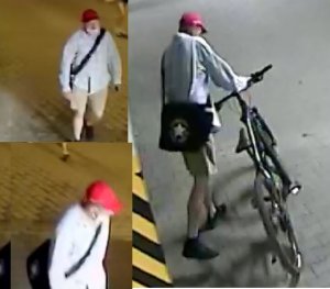 mężczyzna w wieku ok. 20-30 lat, ubrany jest w jasne krótkie spodnie, koszulę z długim rękawem, na głowie ma czapkę z daszkiem koloru czerwonego, torbę przewieszoną przez ramię i maseczkę zasłaniająca usta i nos